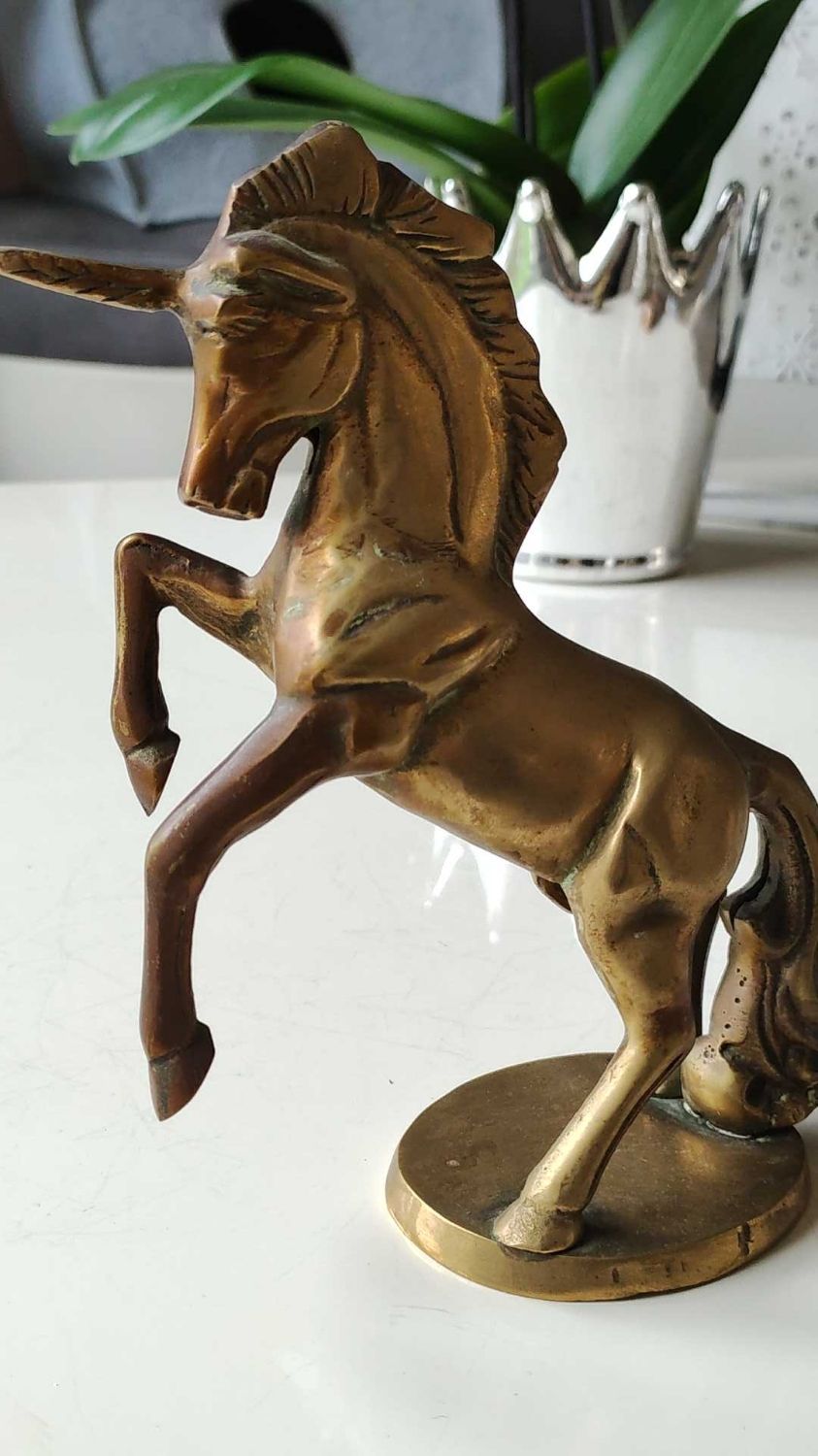 of greenhouse art deco bookends recancing unicorns. solid brass