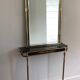Neoclassical style mirror in brass and lacquered sheet metal.