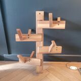 Articulated vertical wall coat rack