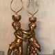 Two carved wooden children, table lamps.