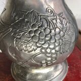 Tin pitcher decorating bunch of grapes