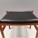 Danish designed footstool in teak wood and black skai “imitation leather”