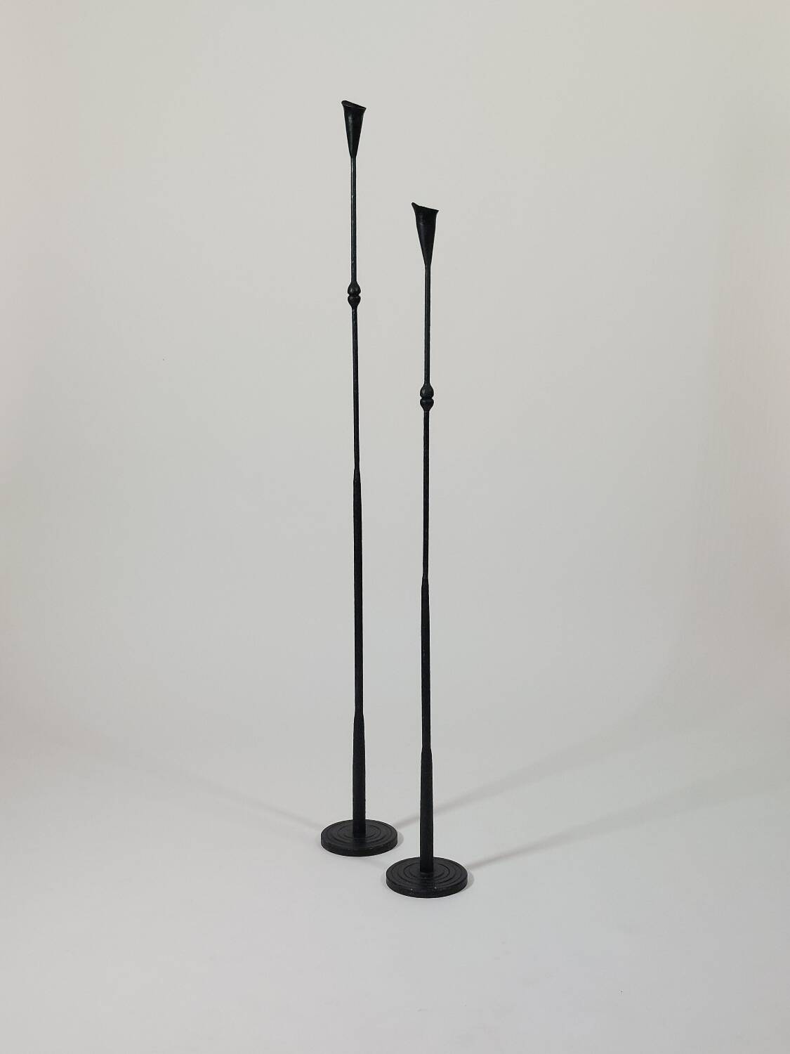 A pair of beautiful and exquisite vintage wrought iron candlesticks from the mid-century.
