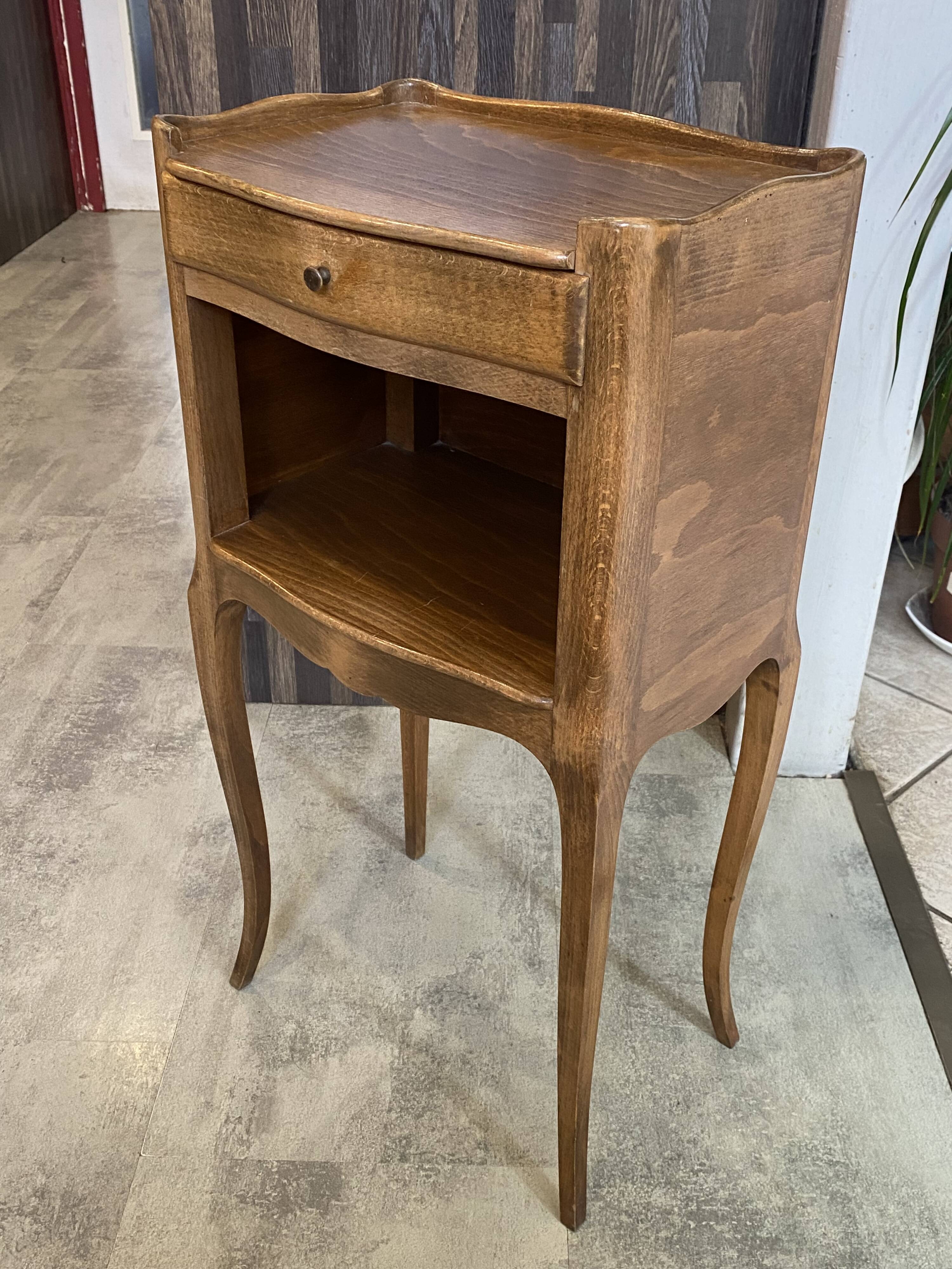 A bedside table with a drawer and a niche in Louis XV style.