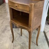 A bedside table with a drawer and a niche in Louis XV style.