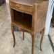 A bedside table with a drawer and a niche in Louis XV style.