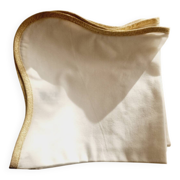 12 D. Porthault white and gold napkins.