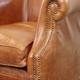 Very comfortable, elegant leather club armchair with a removable seat cushion and timeless design
