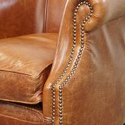 Very comfortable, elegant leather club armchair with a removable seat cushion and timeless design