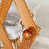 Antique wall-mounted coat rack accordion in dark pine, 10 wooden hooks.