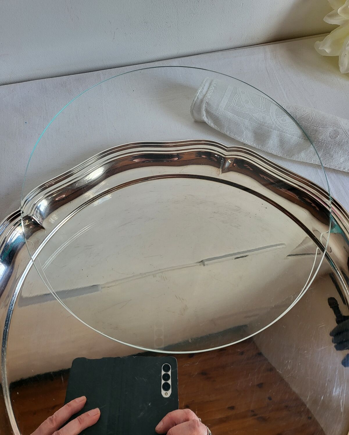 Round silver-plated serving dish with a glass base.