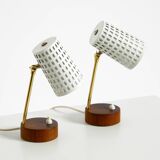 A pair of mid-century modern bedside lamps with perforated metal shades