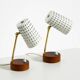 A pair of mid-century modern bedside lamps with perforated metal shades