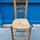 Neo-rustic chair in wood and wicker in the brutalist style by Charles Dudyoyut.