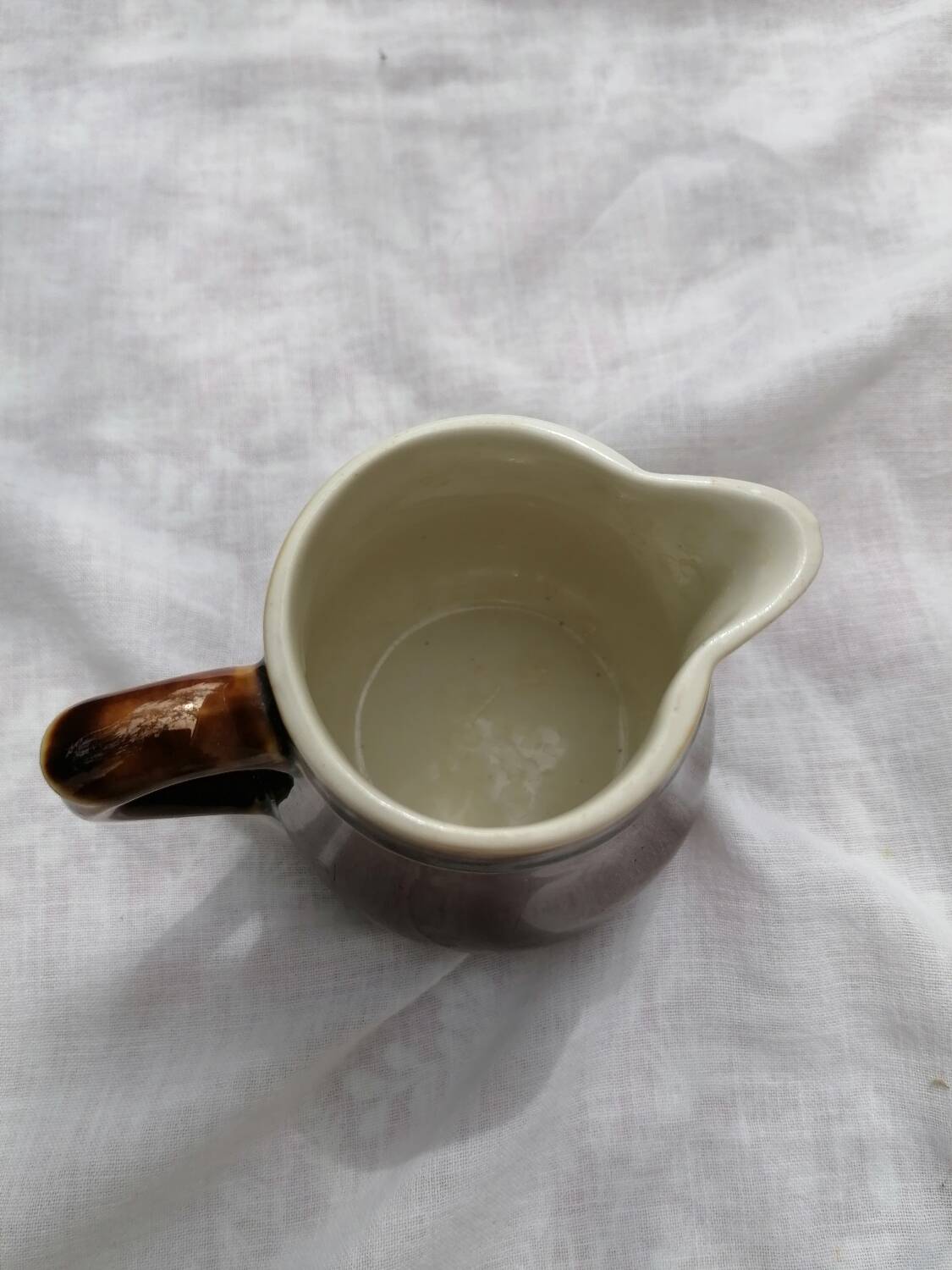 Brown ceramic teapot and milk jugs
