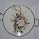 Round white porcelain and metal cake stand, floral decoration, antique style.