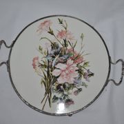 Round white porcelain and metal cake stand, floral decoration, antique style.