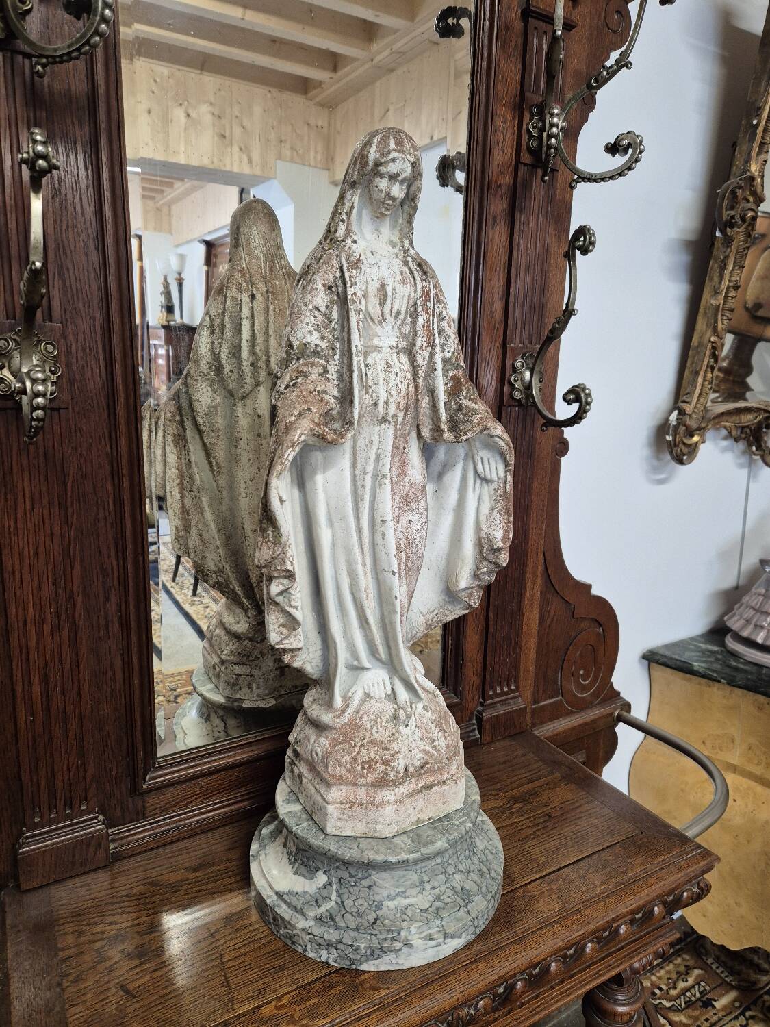 Garden statue of the Virgin Mary in old reconstituted stone