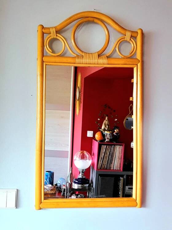 Curved wooden mirror and rattan