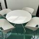 4 Tom Vac chairs designed by Ron Arad with a white round table of 110cm.