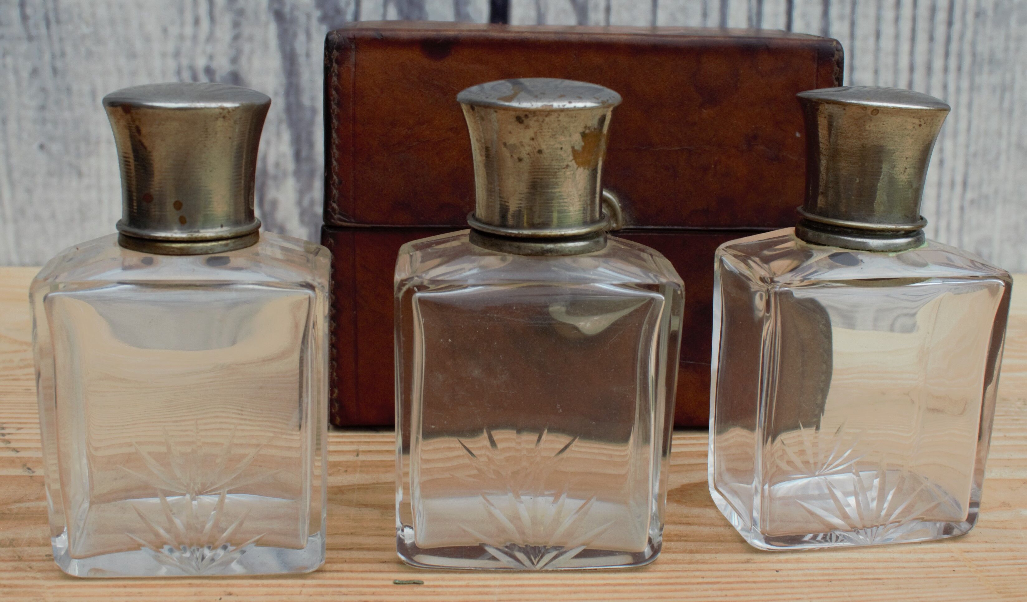 Antique leather case with 3 beveled bottles