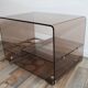 Low table served on wheels by Michel Dumas in vintage 1970 smoky Plexiglas