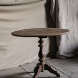 Old oval pedestal table in raw wood