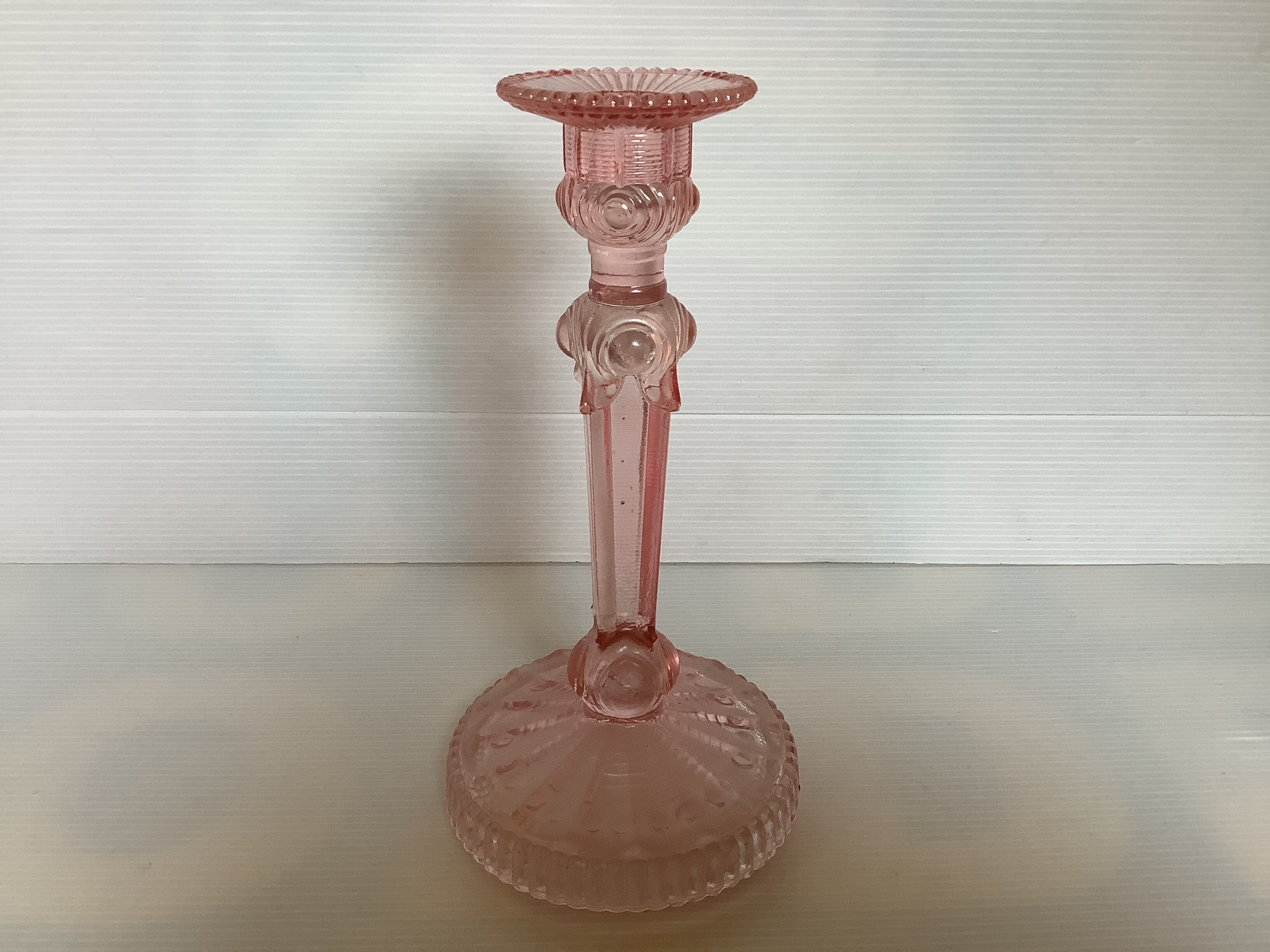 Old pink glass candlestick in Rosaline style.