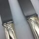 12 silver metal knives.