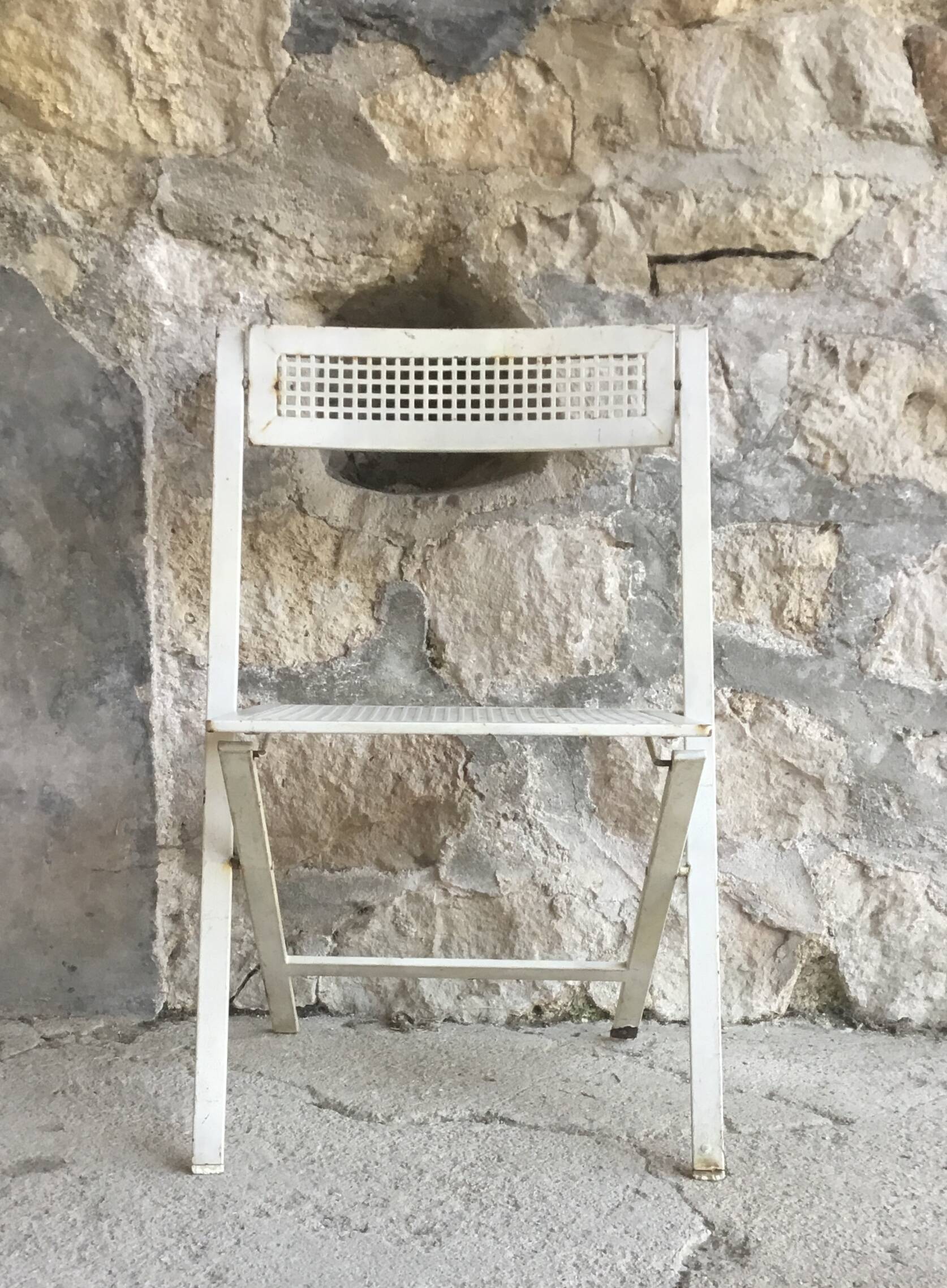 Vintage perforated metal folding chair