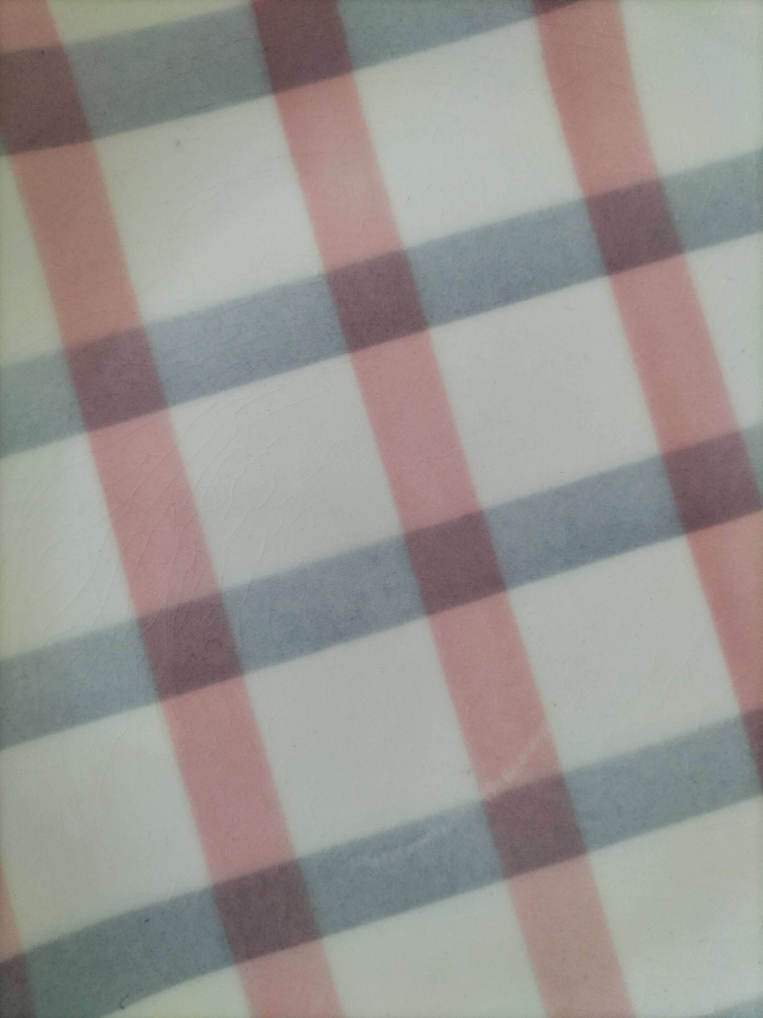 Two dessert plates Moulin des Loups with a pink and grey tablecloth design.