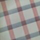 Two dessert plates Moulin des Loups with a pink and grey tablecloth design.