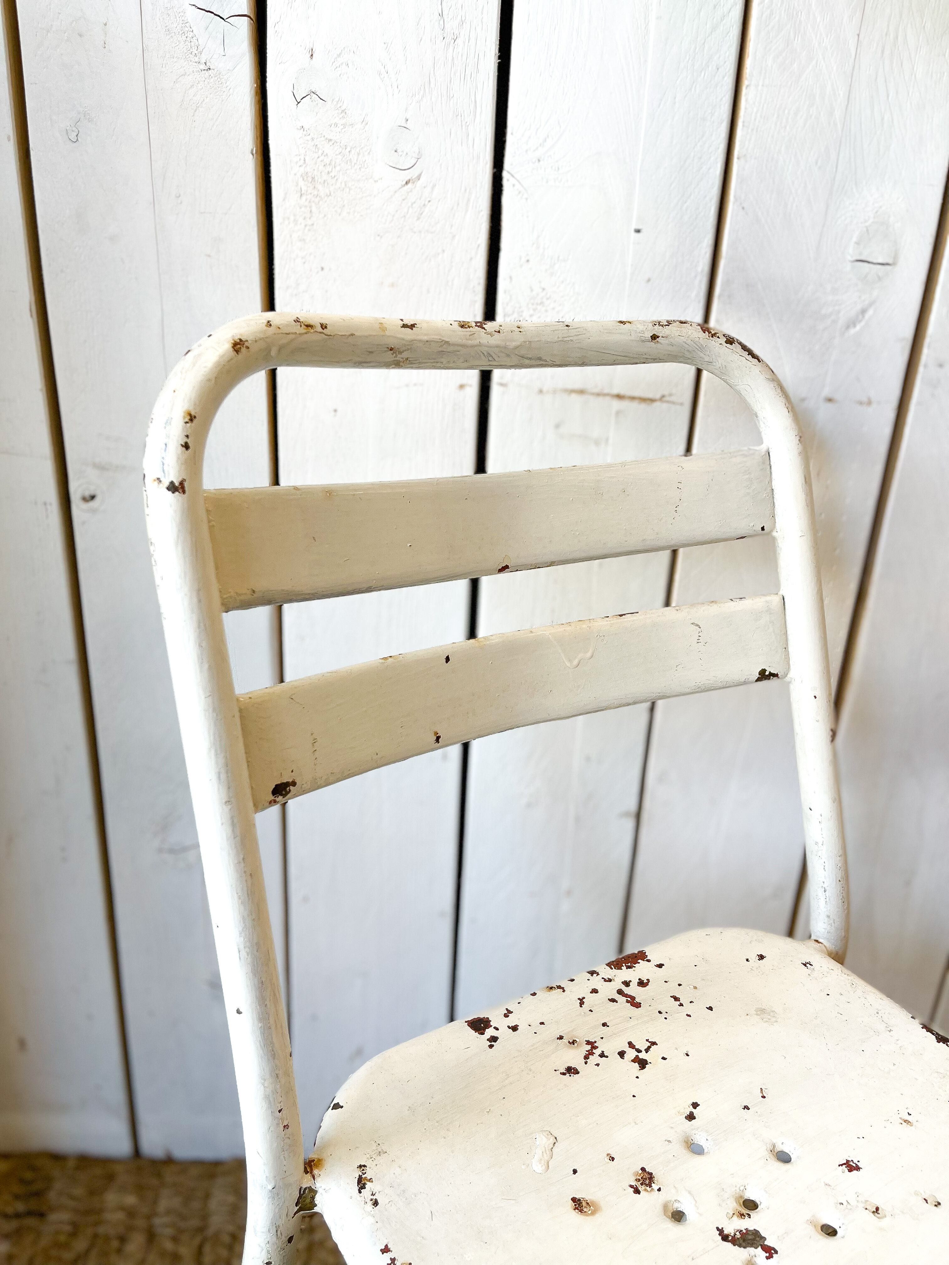 Pair of white metal bistro chairs