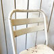 Pair of white metal bistro chairs