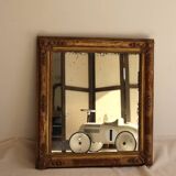 Rectangular mirror in gilded wood with relief decoration of flowers.