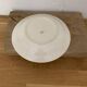 Hungarian folk plate in white ceramic with hand-painted flowers, embossed edge.