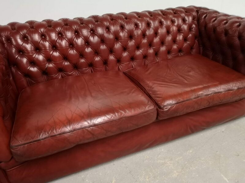 Old red leather Chesterfield sofa