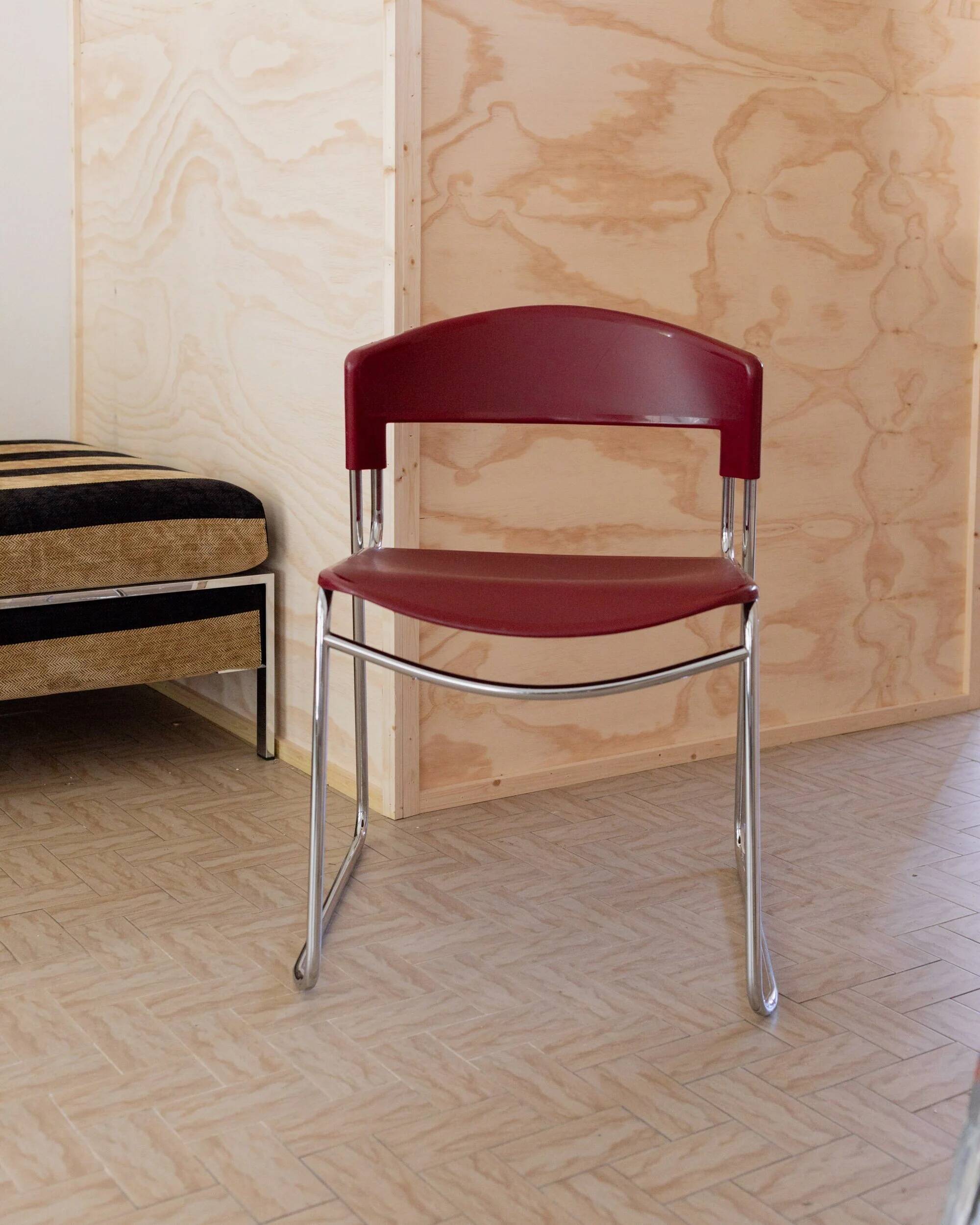 Red plastic-seat stacking chair with chrome frame by Paolo Favaretto for Assisa (Italy 1986) – vintage design