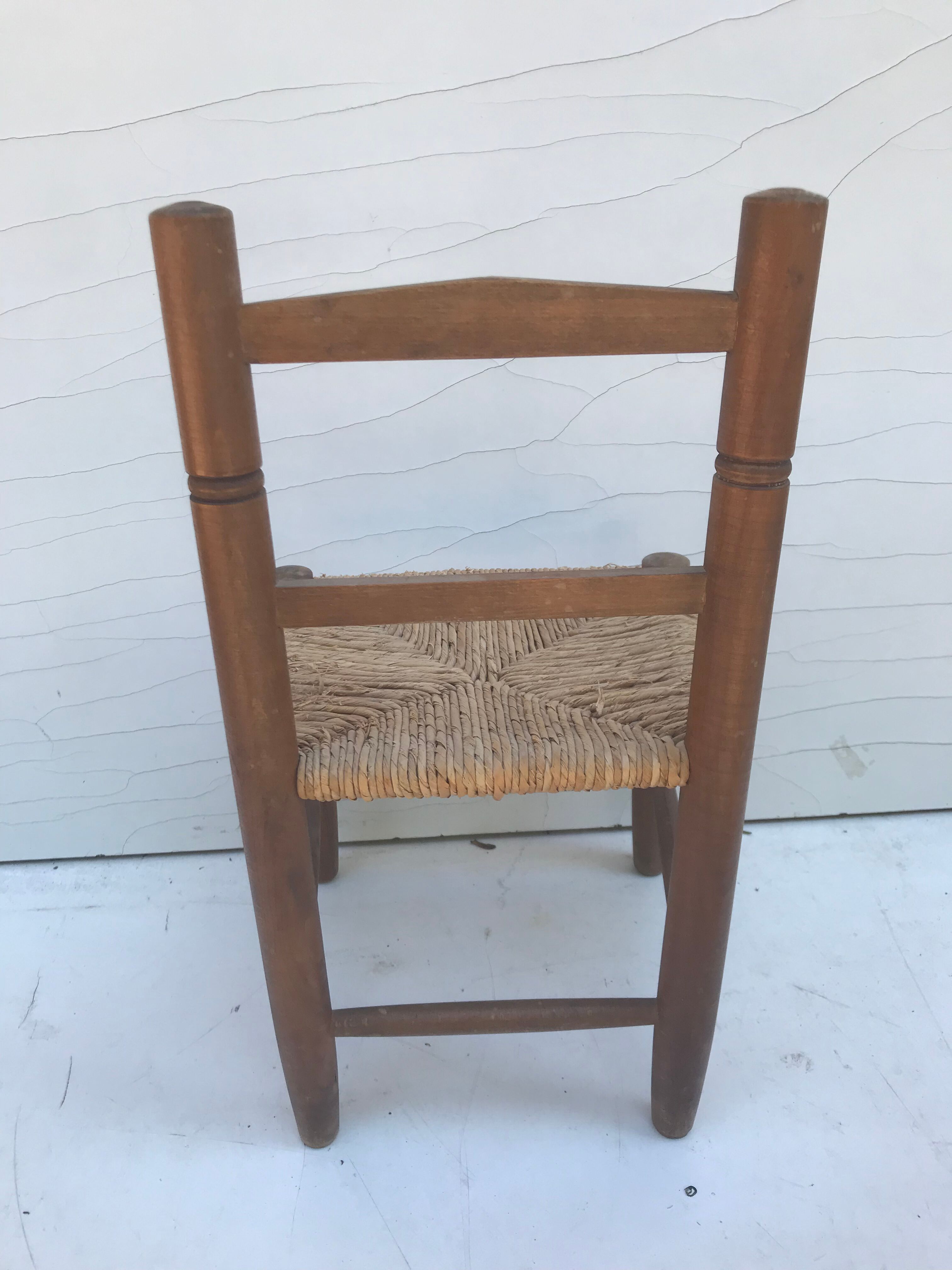 Old wooden children's chair with vintage braided seat