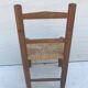 Old wooden children's chair with vintage braided seat