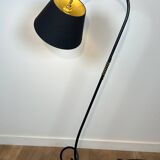 Design floor lamp in black lacquered metal and brass.