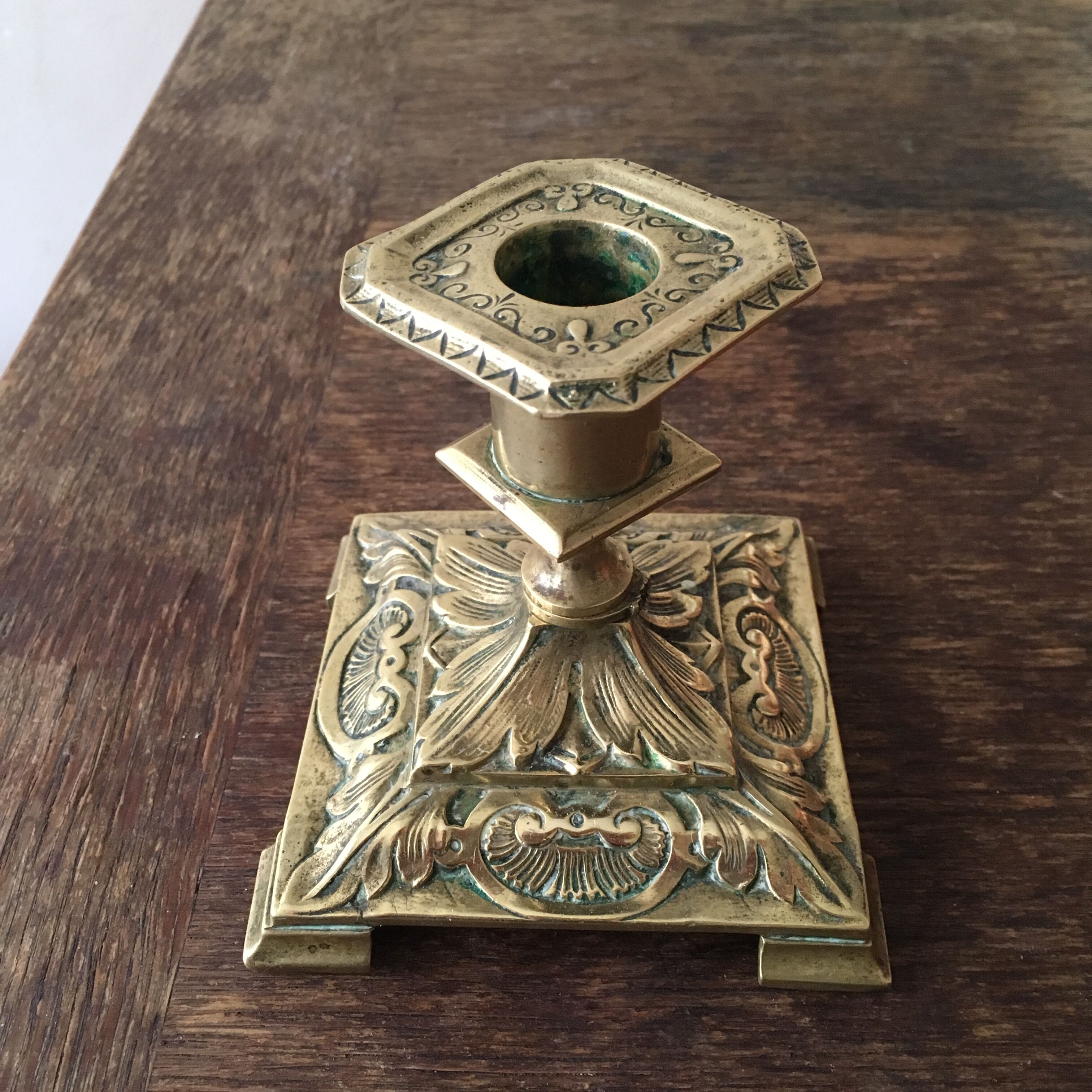 Old brass candle holder with square base