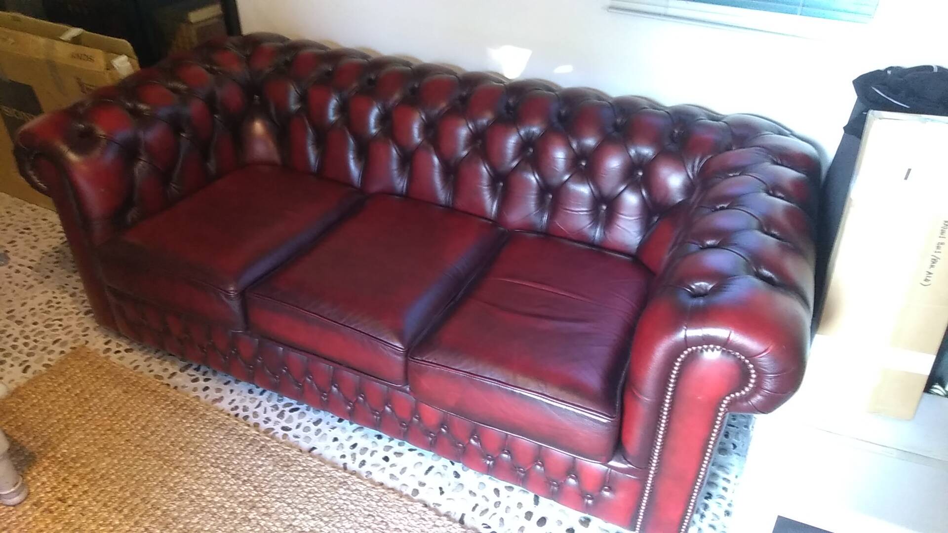 Burgundy Chesterfield-style sofa