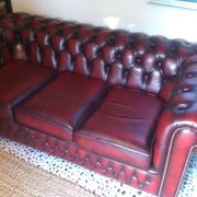 Burgundy Chesterfield-style sofa