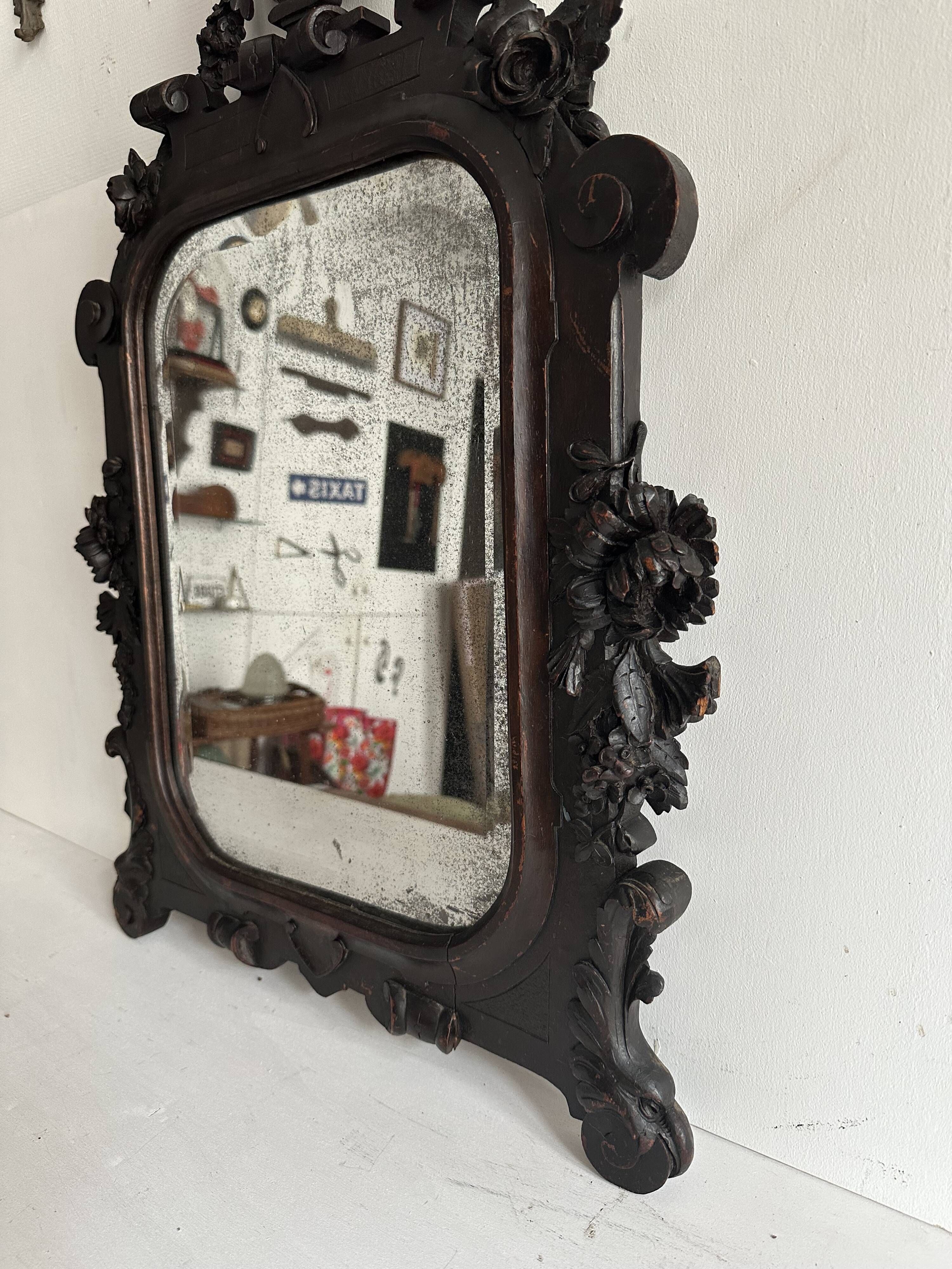 Napoleon III mirror in carved blackened wood, 19th century