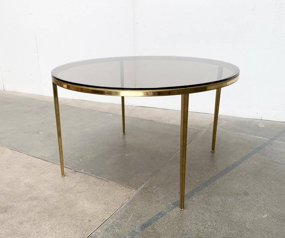 Mid-century Hollywood Regency style coffee table in brass and glass, made in Germany by Vereinigte Werkstätten, 1960s.