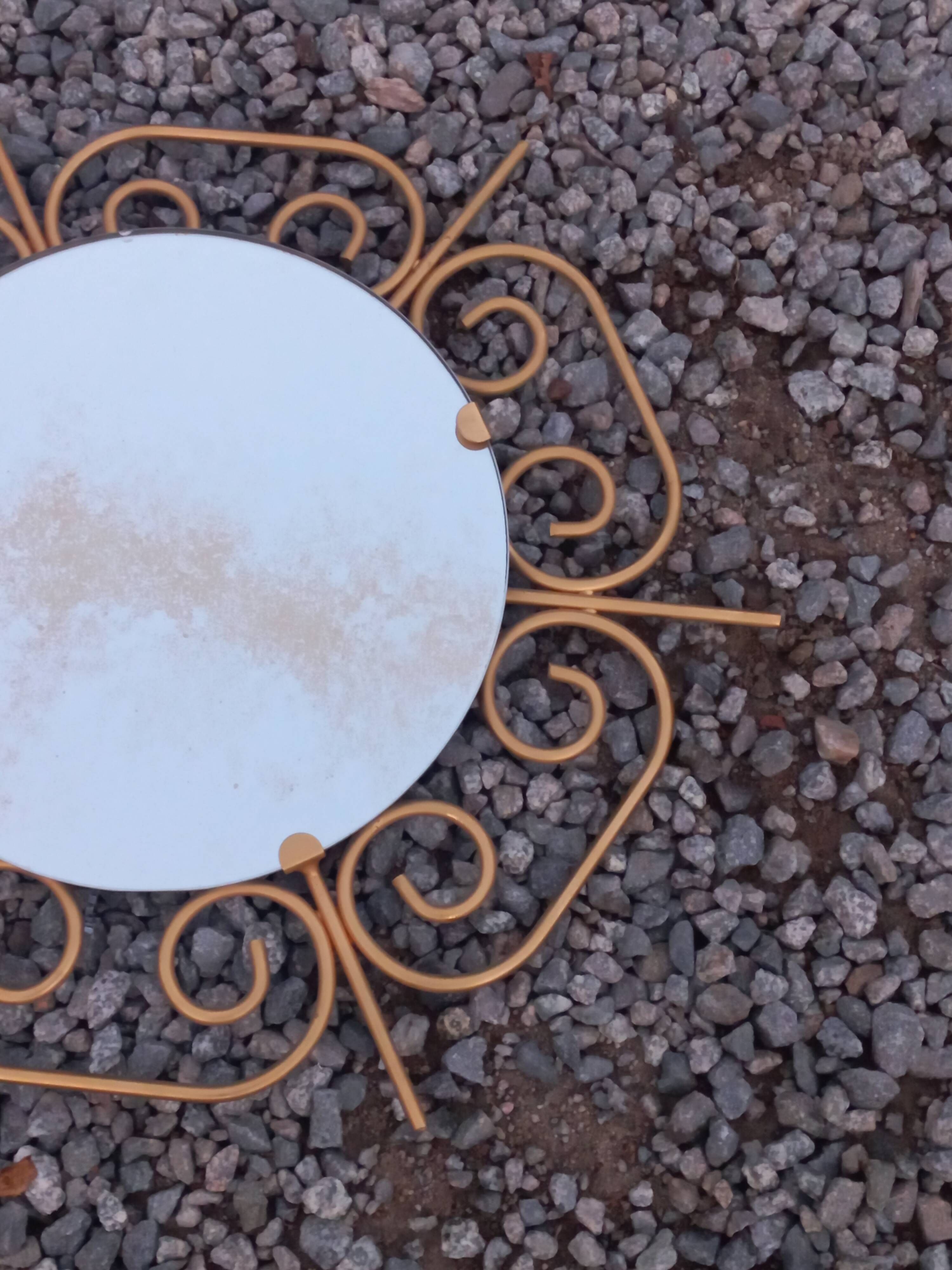 Golden metal sun mirror from the 1950s.