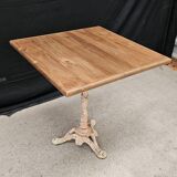Bistro table with cast iron base and solid teak top