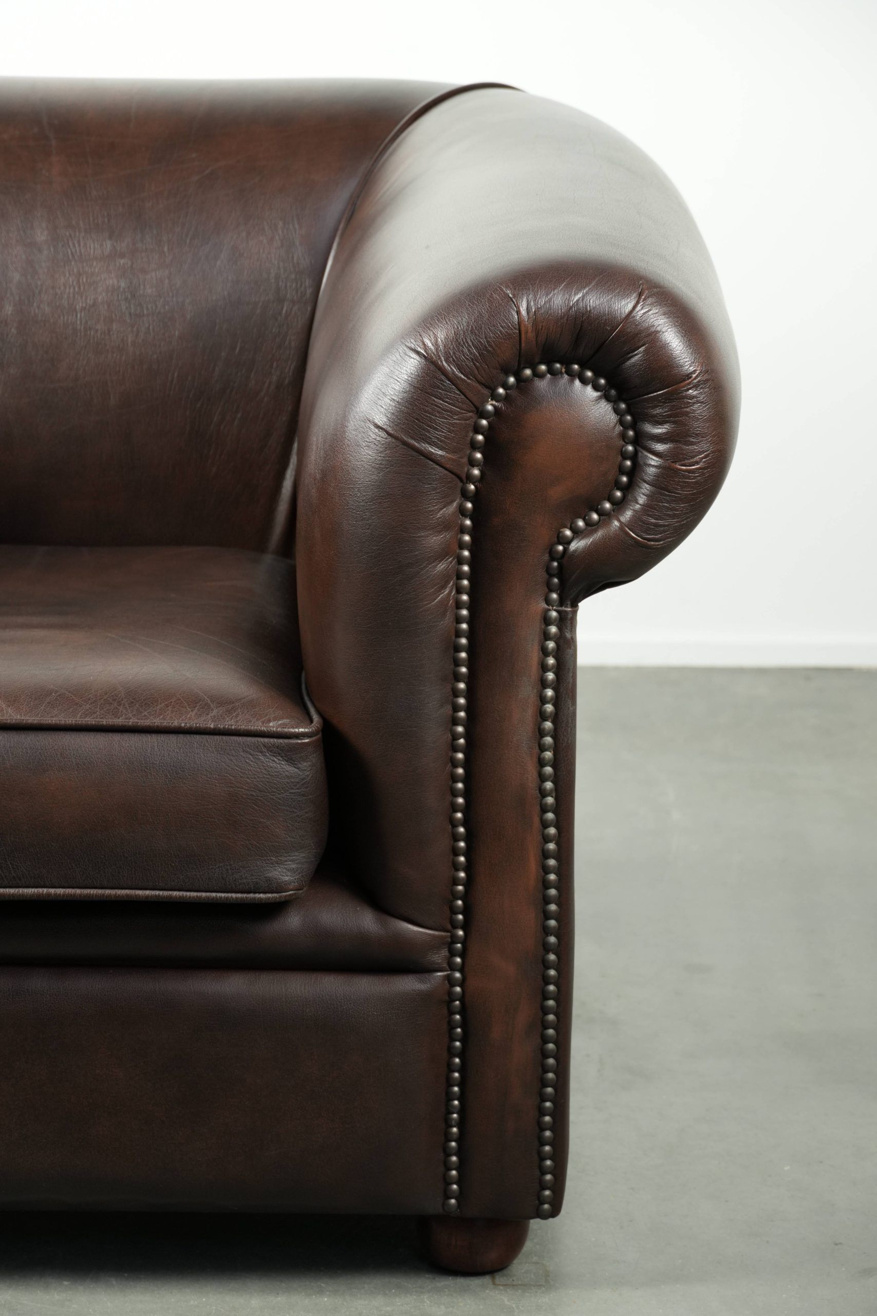 Luxury brown cow leather Chesterfield armchair with a timeless English look