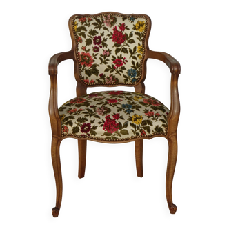Convertible armchair with brocade fabric and floral patterns.